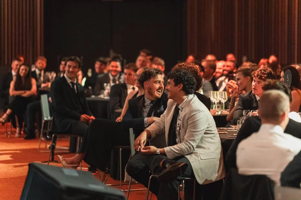 Guests seated at tables at a formal evening industry event